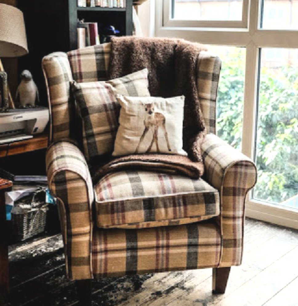Neyland Star Tartan Fabric Wingback Tub Chair in a cosy corner of a living room