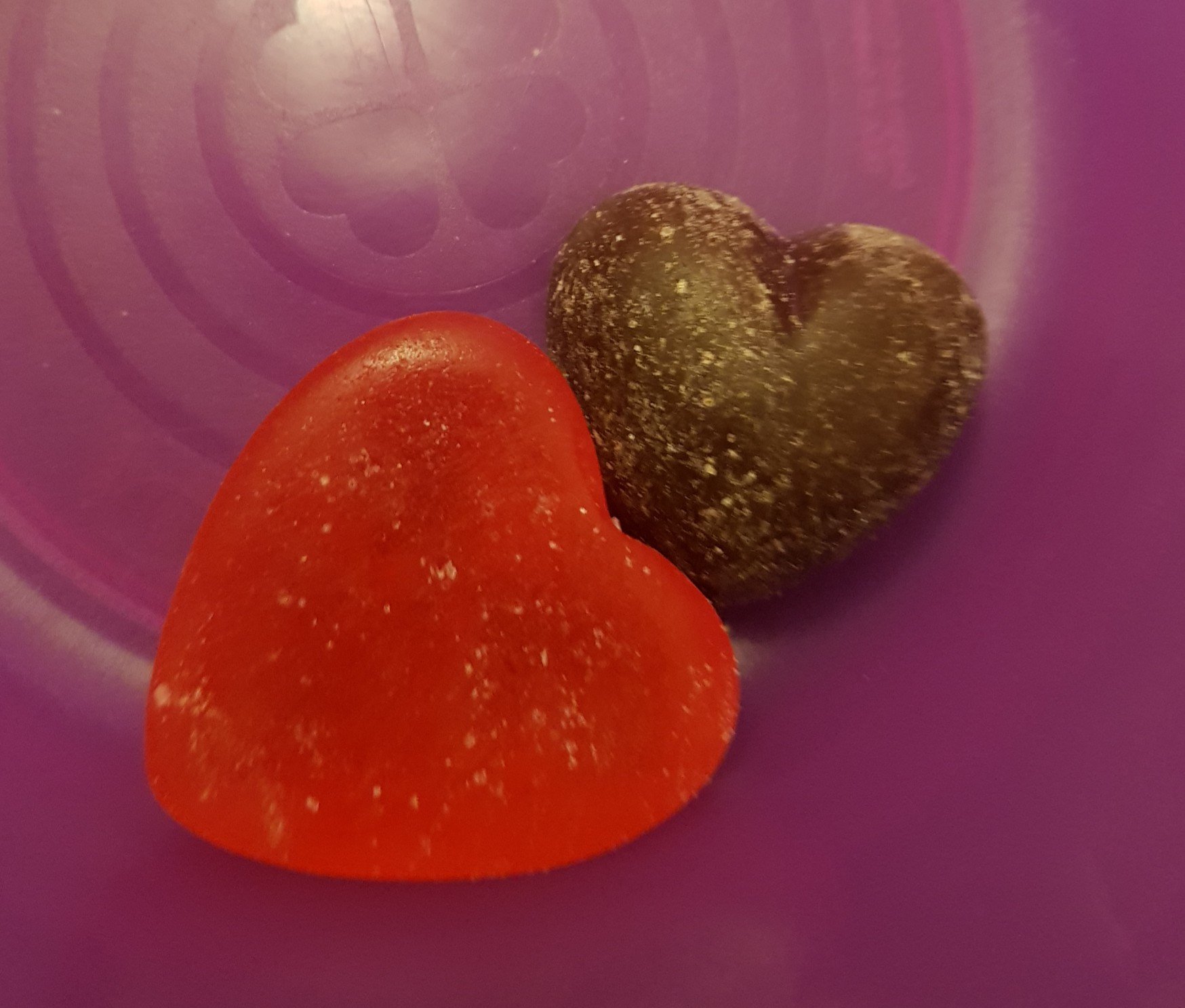 Two hearts - one sweet and one chocolate - in a bowl.