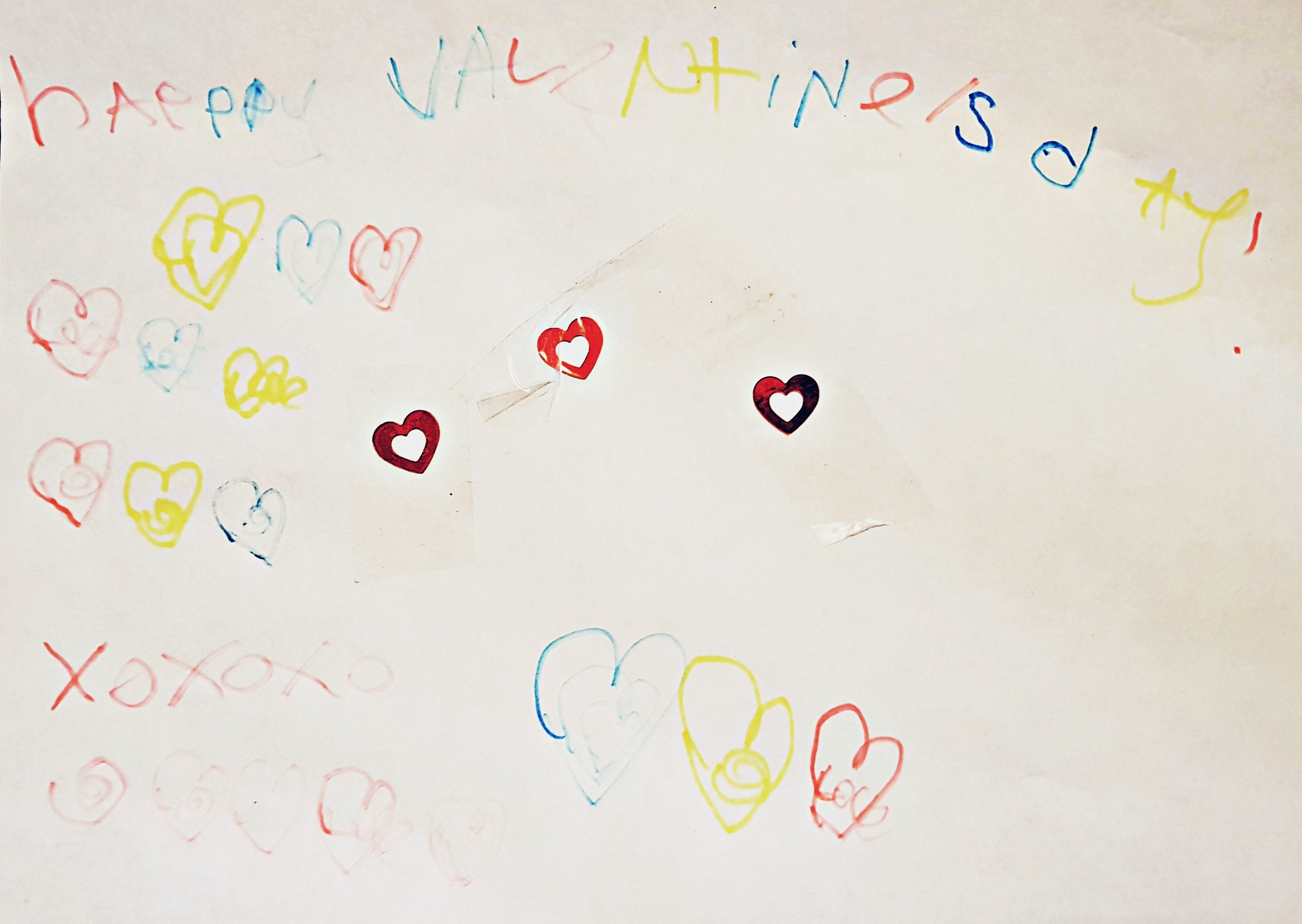 Happy valentines day message with lots of colourful hearts drawn and written by Squiggle.