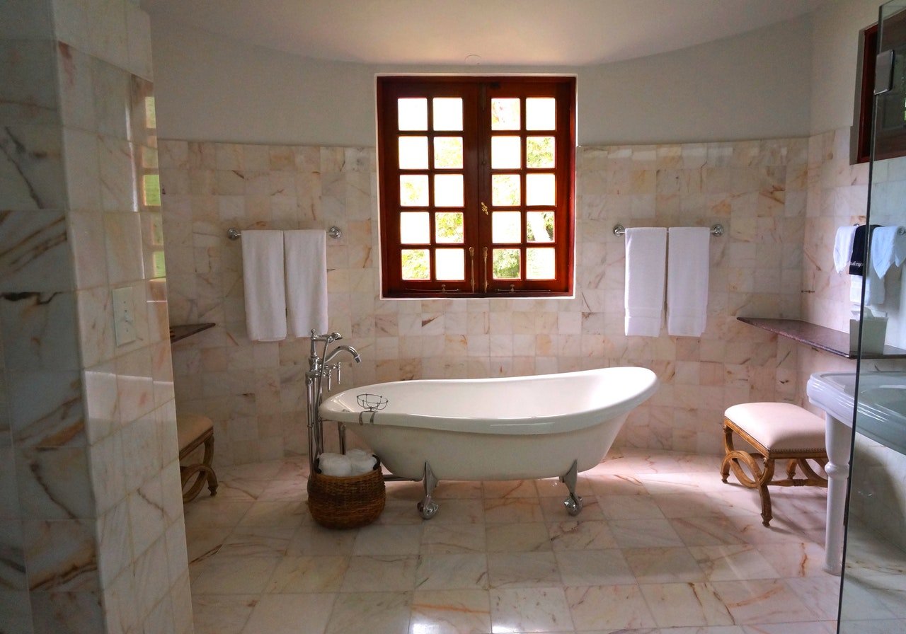 A lovely bathroom with typical bathroom features including a comfy stool 