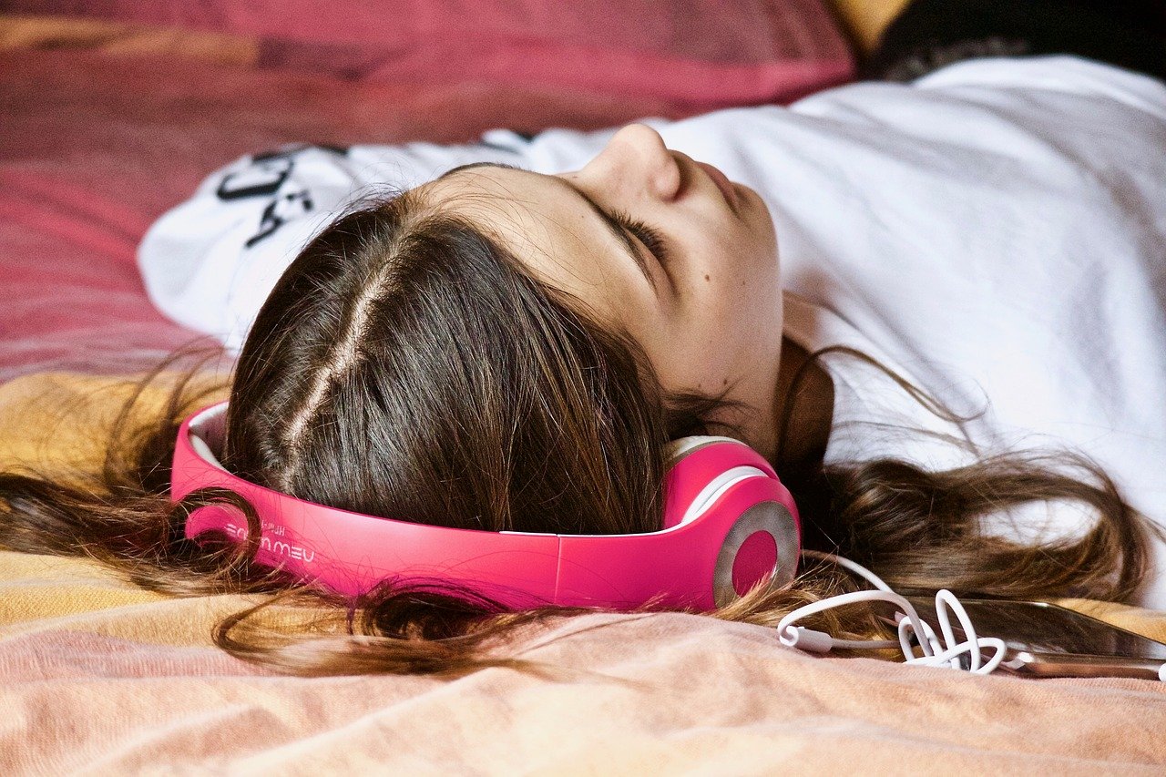 Girl sleeping with headphones on