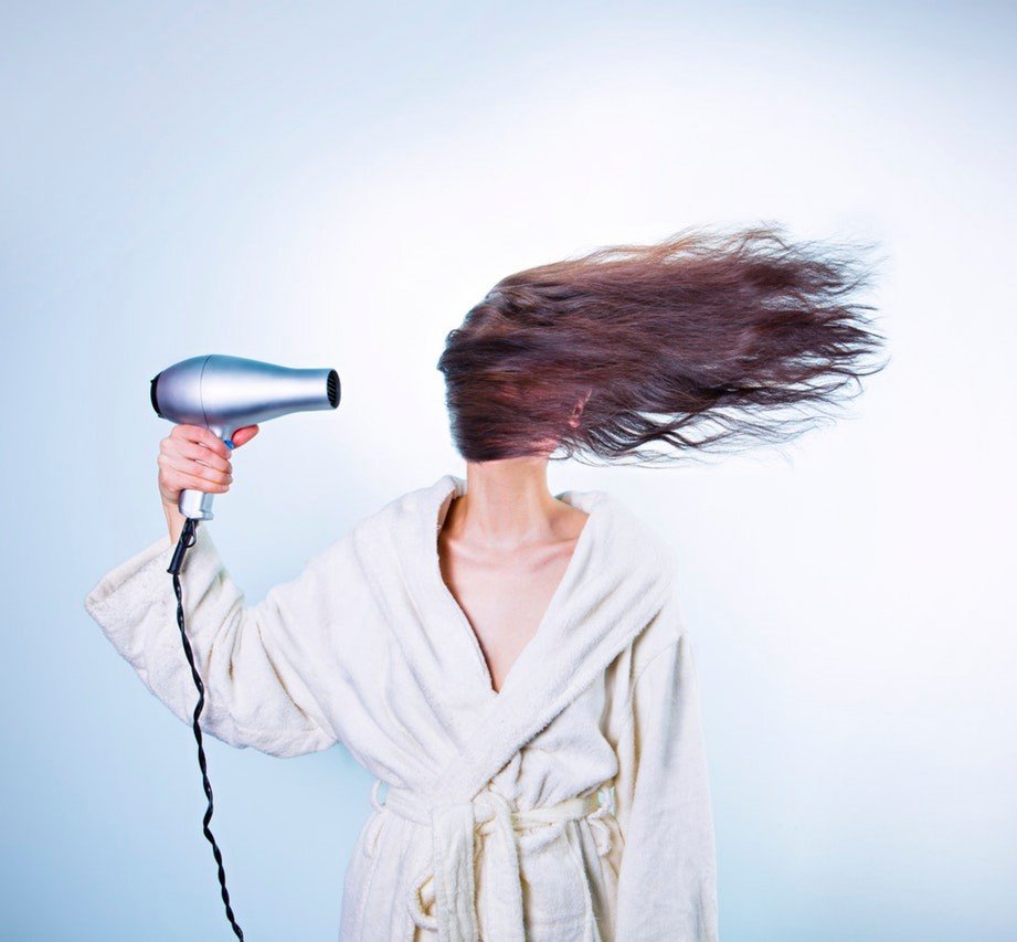 A lady drying her hair