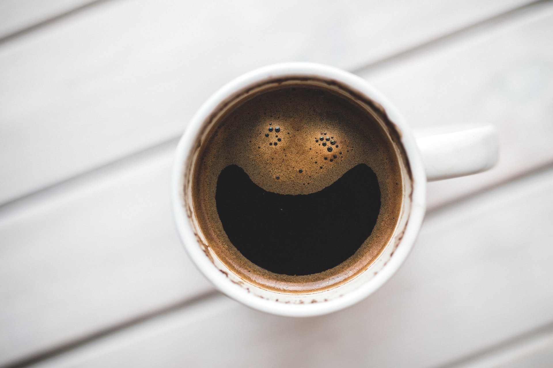 Cup of coffee. Smily face in coffee