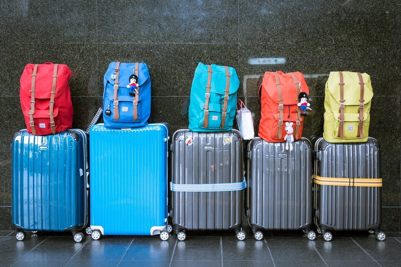 A row of suitcases and backpacks. Luggage. 