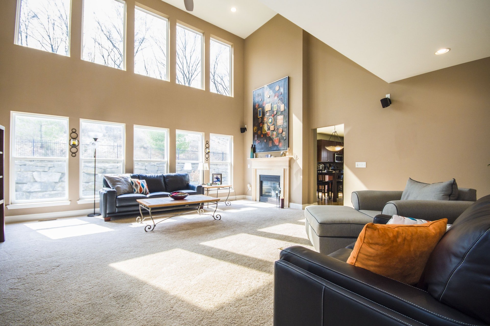 A living room with huge windows flooding the room with natural light