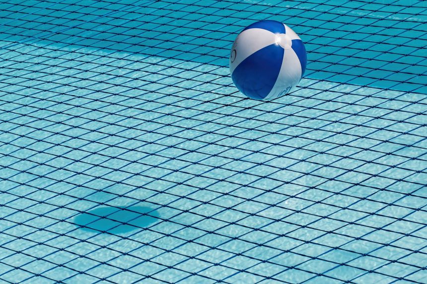 A blue and white inflatable ball in a swimming pool
