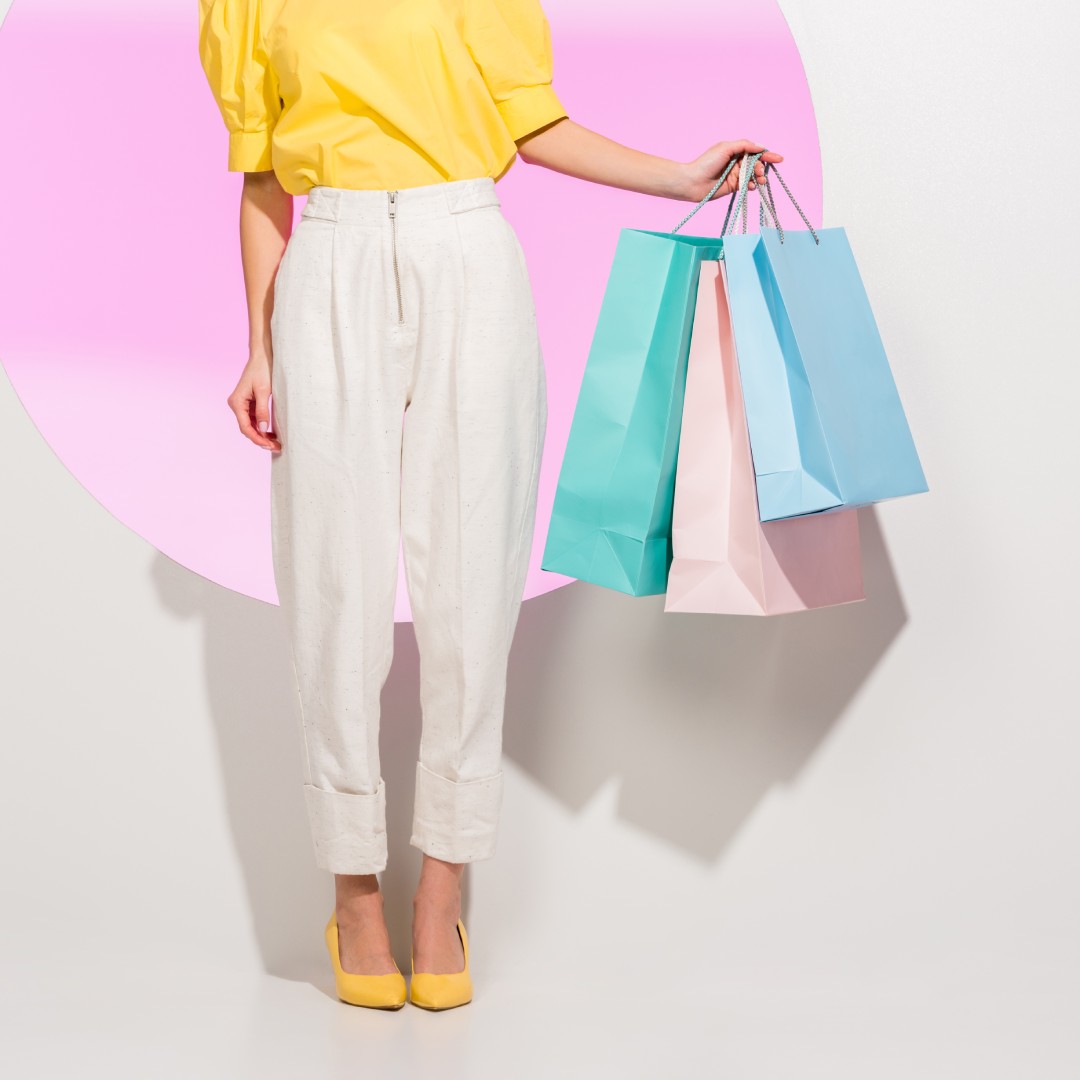 A shopper heavily influenced by marketing color psychology, holding solid color shopping bags.